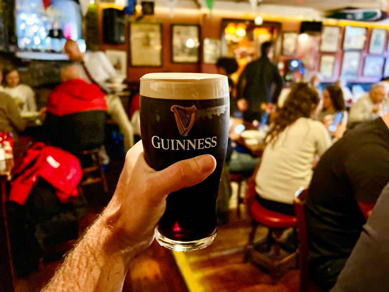Man holding a Guinness in an Irish Pub in Ireland
