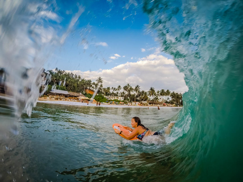 Lina Stock of Divergent Travelers Adventure Travel blog playing in the waves in Sri Lanka