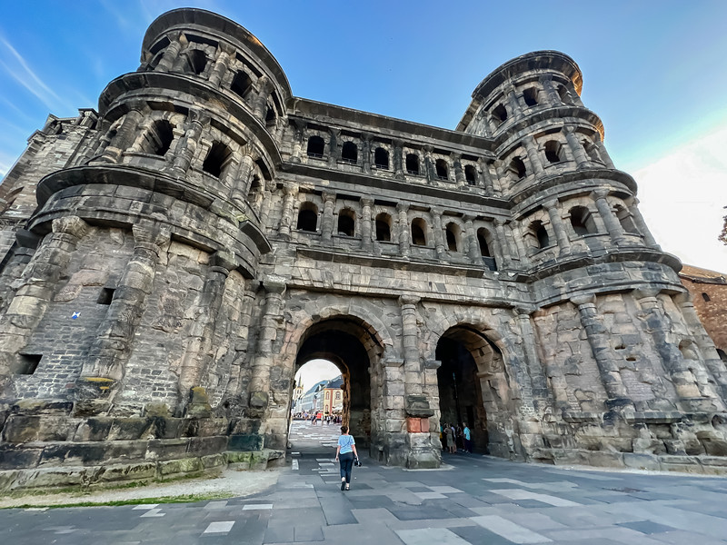 Lina Stock walking under the Porta Nigra gate in Trier, Germany in the Moselle Valley