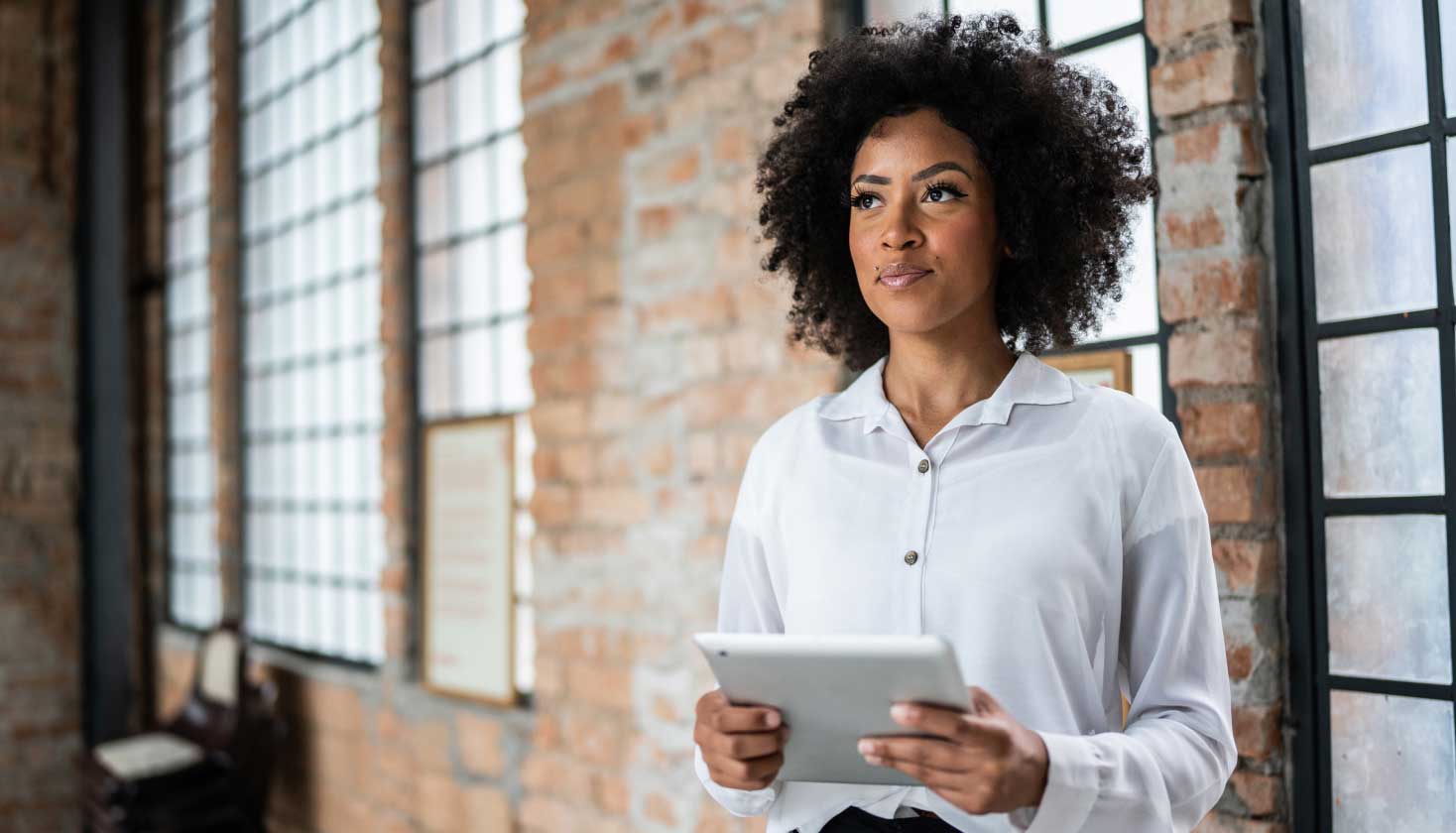 A person using a tablet, presumably to find answers to questions about business intelligence tools