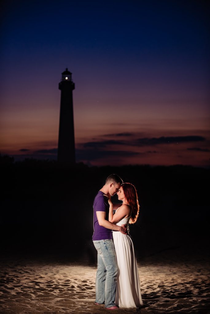 couple shares a kiss on the shores of willwood New Jersey during their beach e- session
