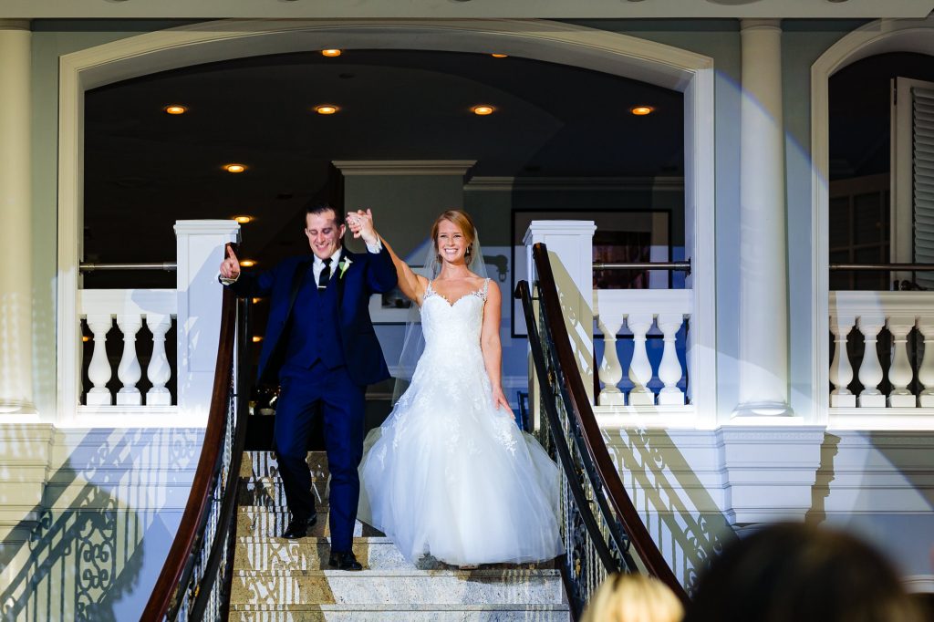 Bride and groom walking down stairs at the Arts Ballroom