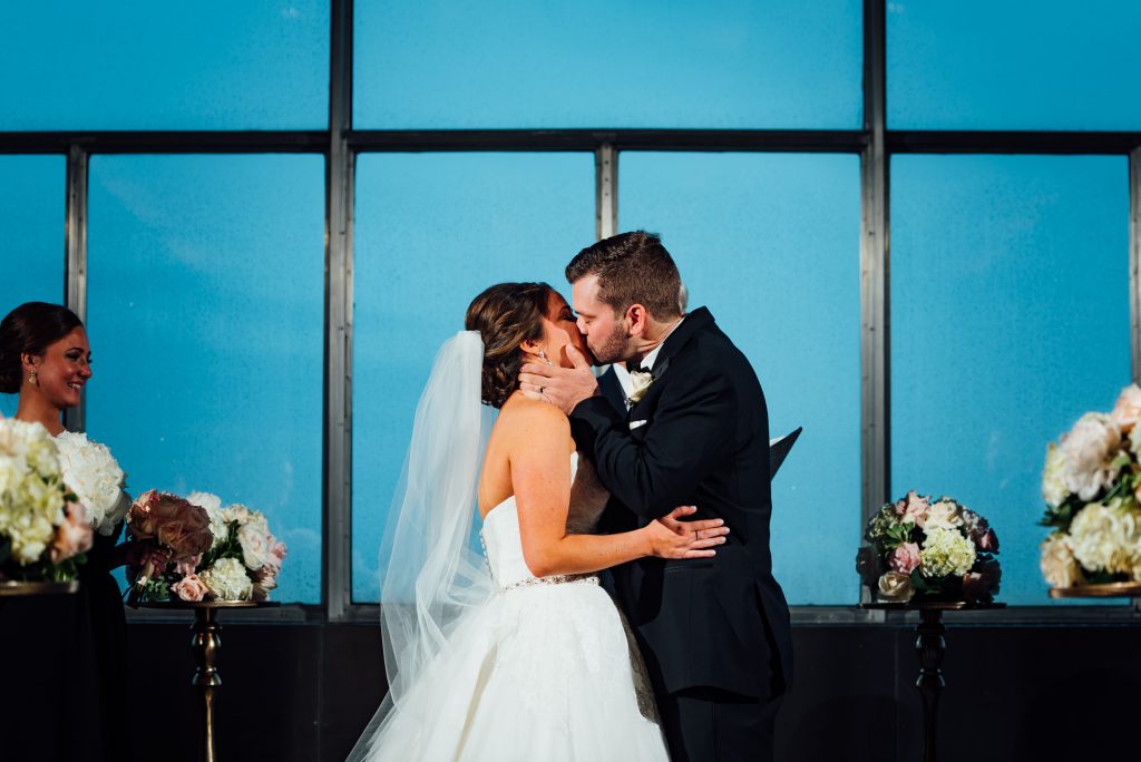 bride and groom first kiss at the Loews Hotel in Philadelphia