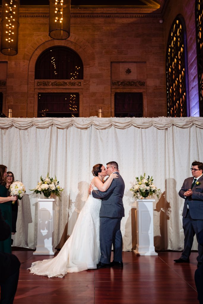 bride and groom first kiss as married couple on their union trust philadelphia wedding