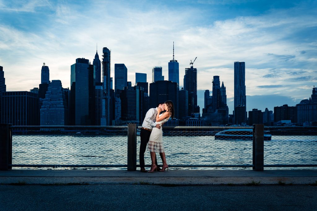 couple embracing at their Brooklin Bridge Park eshoot