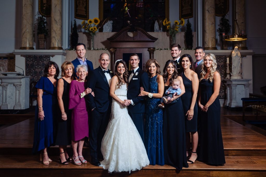 bride and groom with their family shot