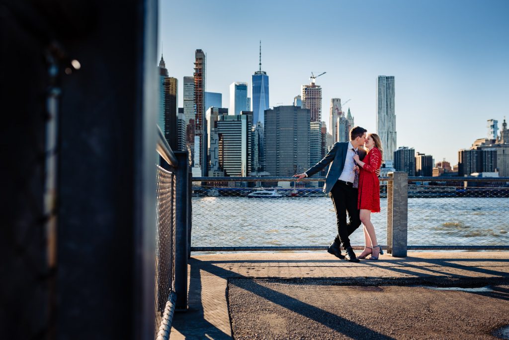 couple shares a kiss during engagement photoshoot taken at dumbo new york