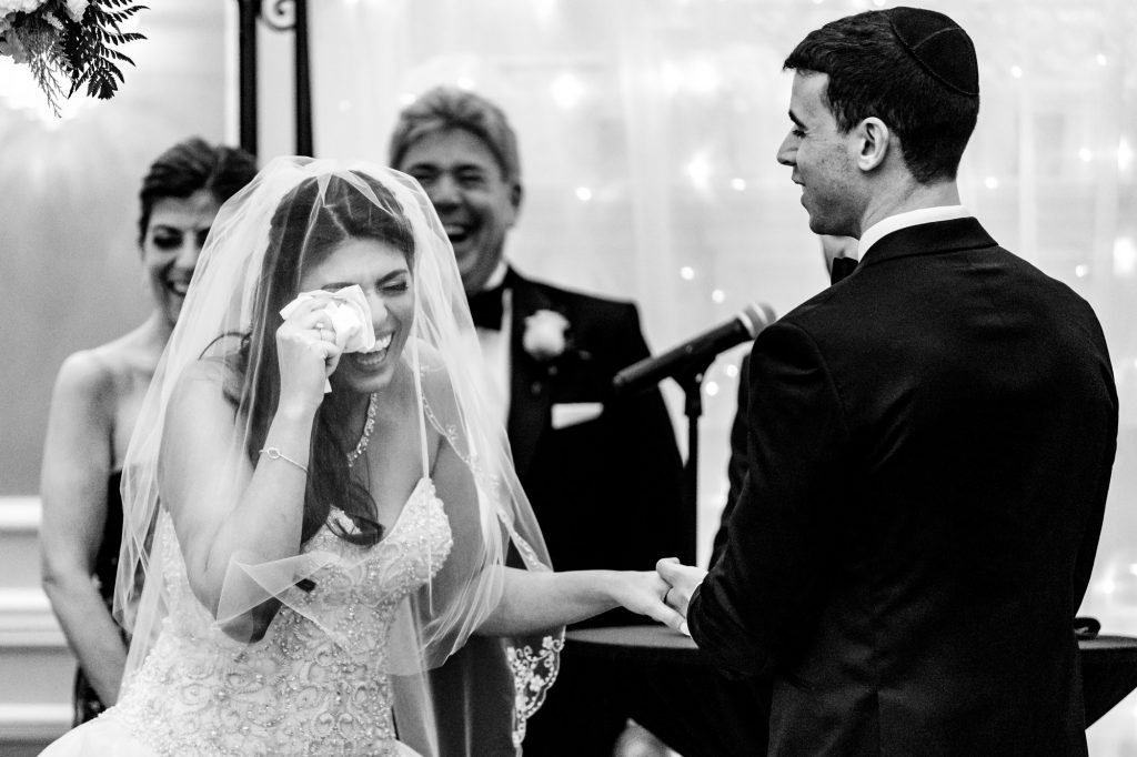 bride laughing and wiping away tears during her Arts Ballroom ceremony