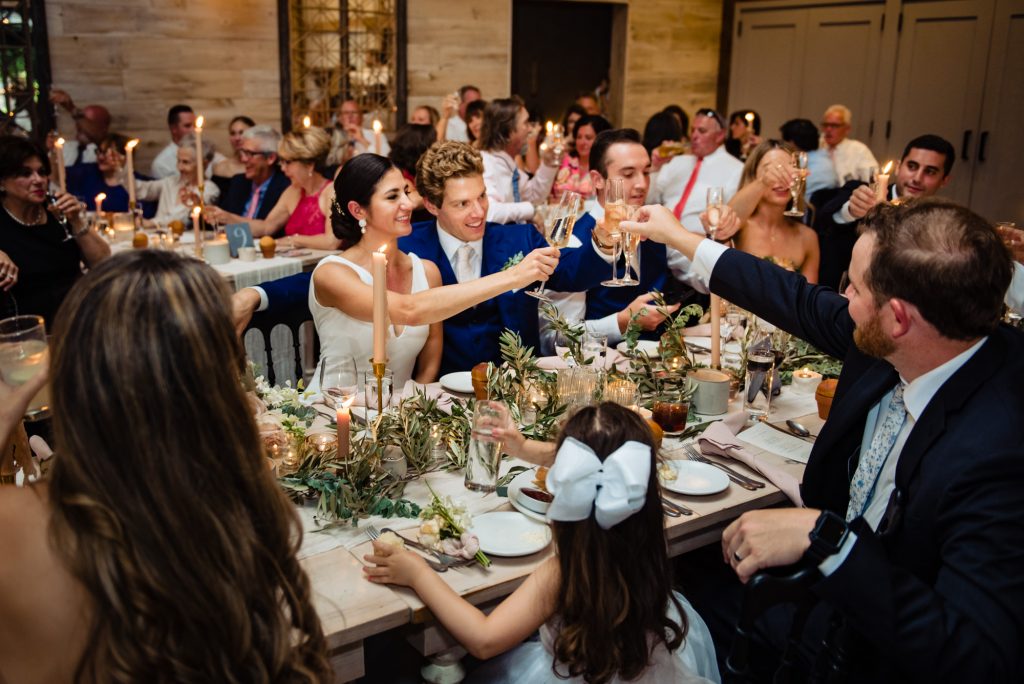 couple sharing a toast with their guests during their wedding reception