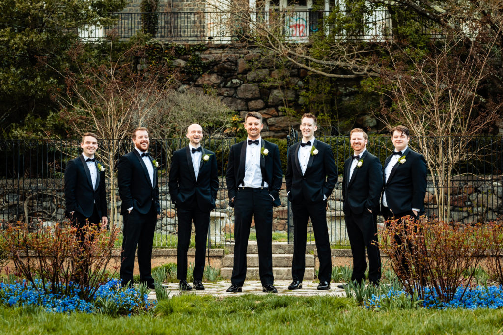 Formal landscape full body shot of the groom and groomsmen