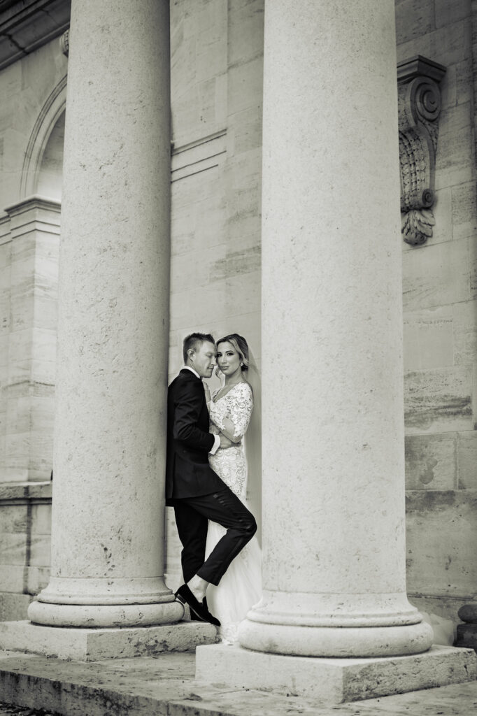 black and white shot of groom and bride posing outside