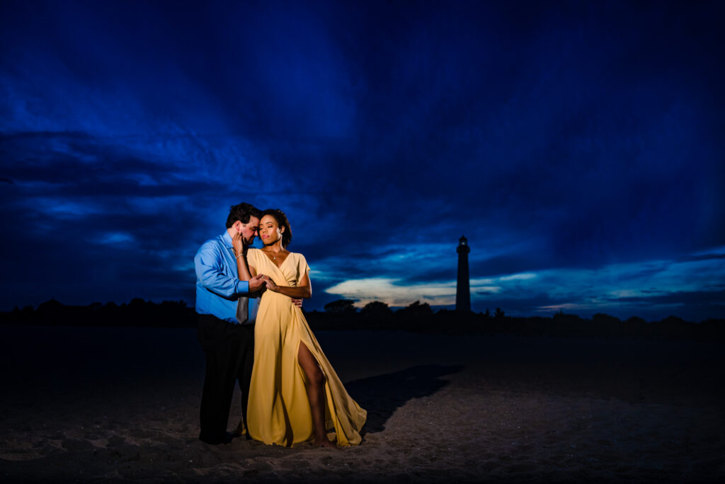couple shares a kiss on the shores of willwood New Jersey during their beach e- session