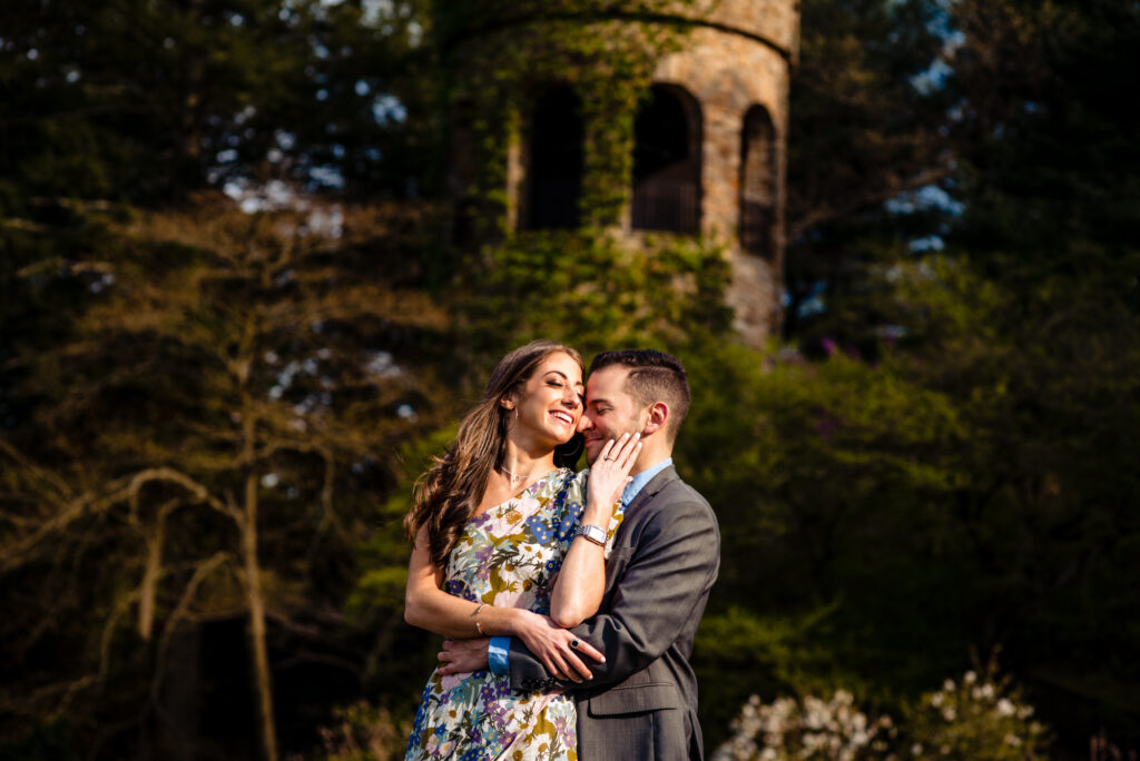 an engagement shoot taken outside the bell tower of the Chimes Tower District section of longwood gardens