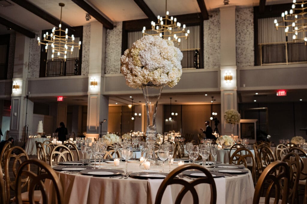 elegant decorations at The Lucy wedding venue with hanging chandeliers and white flowers as centerpiece