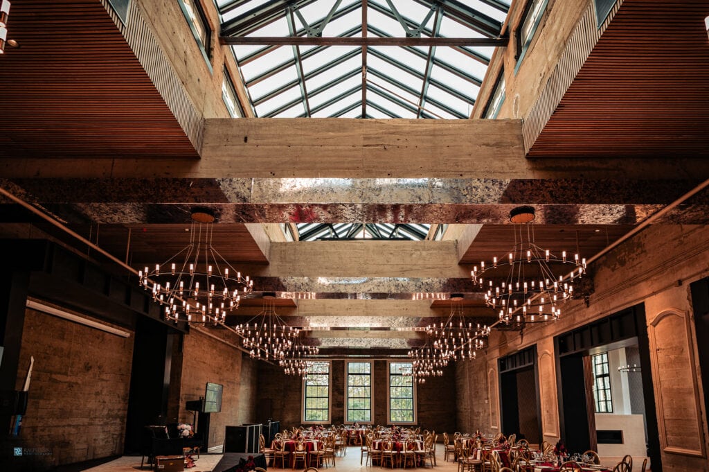 the wedding reception of the switch house by cescaphe draped in red decors with dazzling large chandeliers adding its sophisticated look.