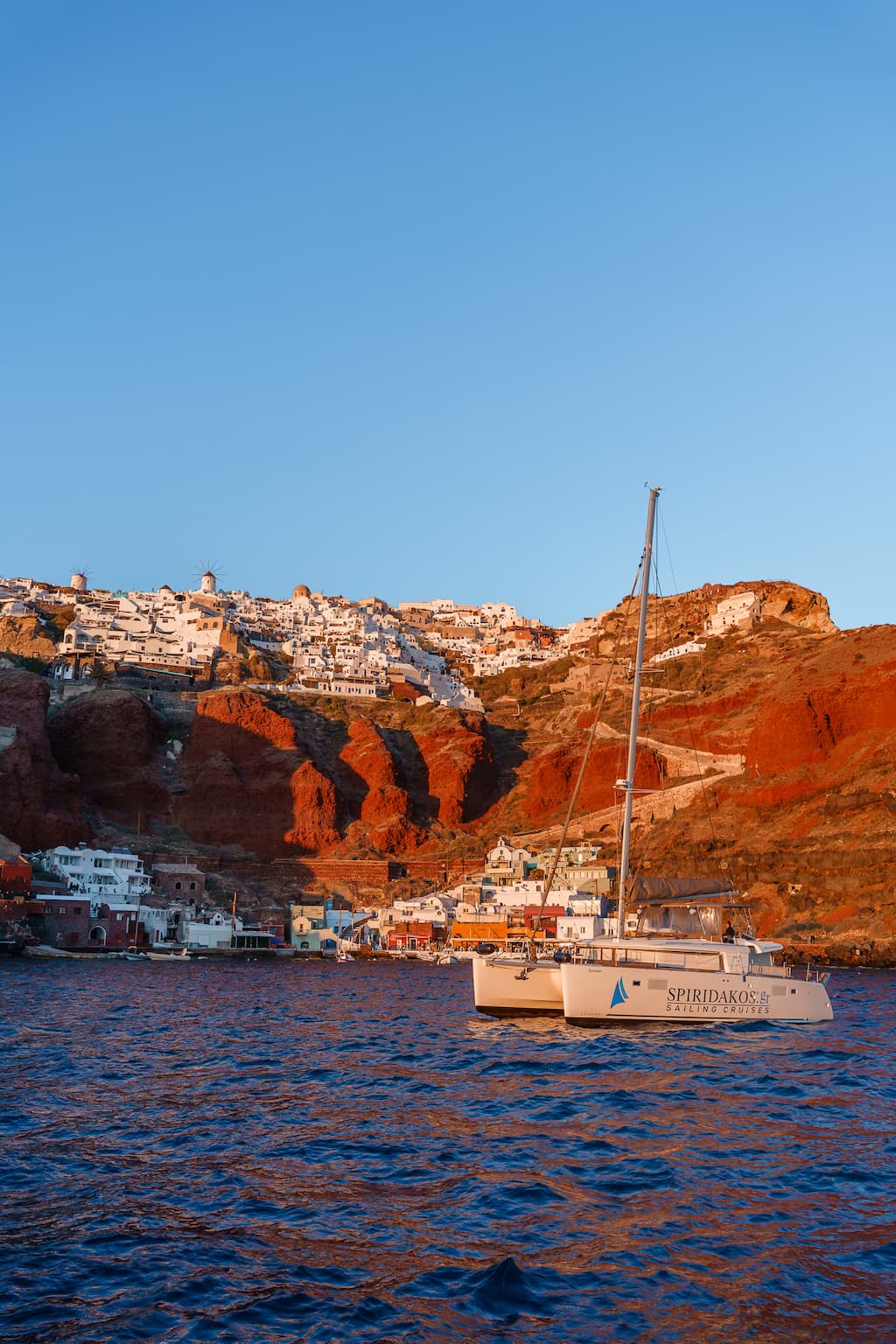 Best sunset cruises in Santorini end in Amoudi Bay to watch the famed Santorini sunset.