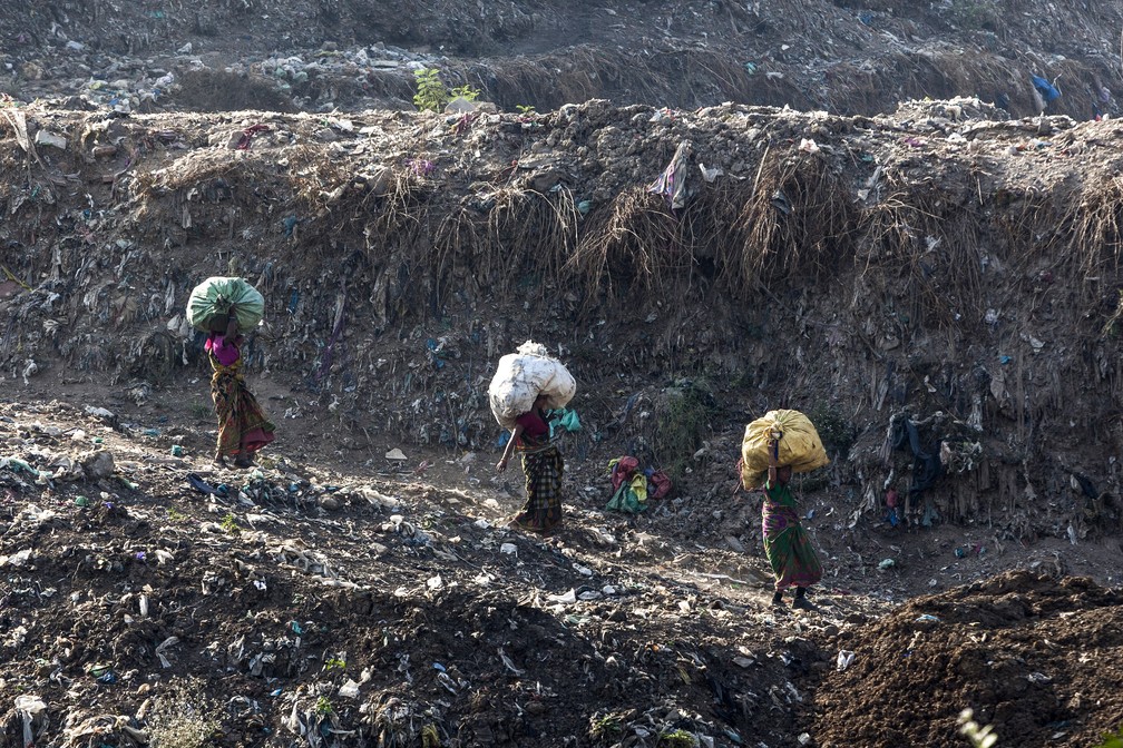 Moradores recolhem lixo de Ghazipur, o maior lixão de Nova Délhi. — Foto: Xavier Galiana/AFP