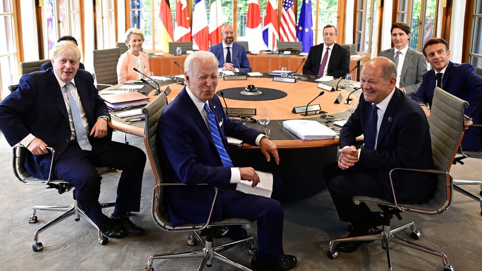 Joe Biden (EUA), Boris Johnson (Reino Unido), Fumio Kishida (Japão), Ursula von der Leyen (Comissão Europeia), Charles Michel (Conselho Europeu), Mario Draghi (Itália), Justin Trudeau (Canadá), Emmanuel Macron (França) e Olaf Scholz (Alemanha) riem em mesa de trabalho da cúpula do G7 na Alemanha, em 26 de junho de 2022. — Foto: John MacDougall via AP
