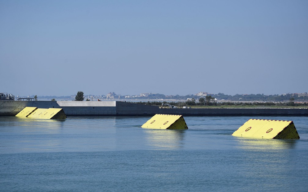Barreiras móveis amarelas são vistas na superfície da água durante testes do projeto Mose, em Veneza, na Itália, na sexta-feira (10) — Foto:  Reuters/Flavio Lo Scalzo 