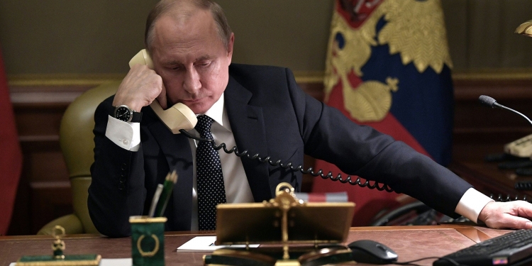 Vladimir Putin holding telephone talks.