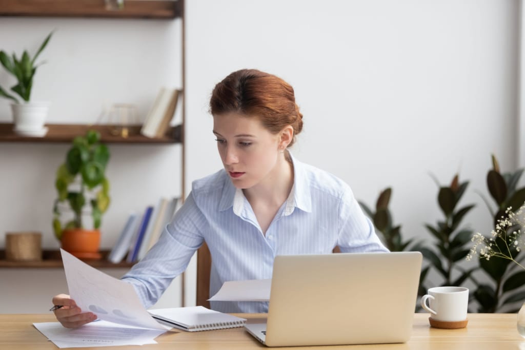 Woman looking at financial papers