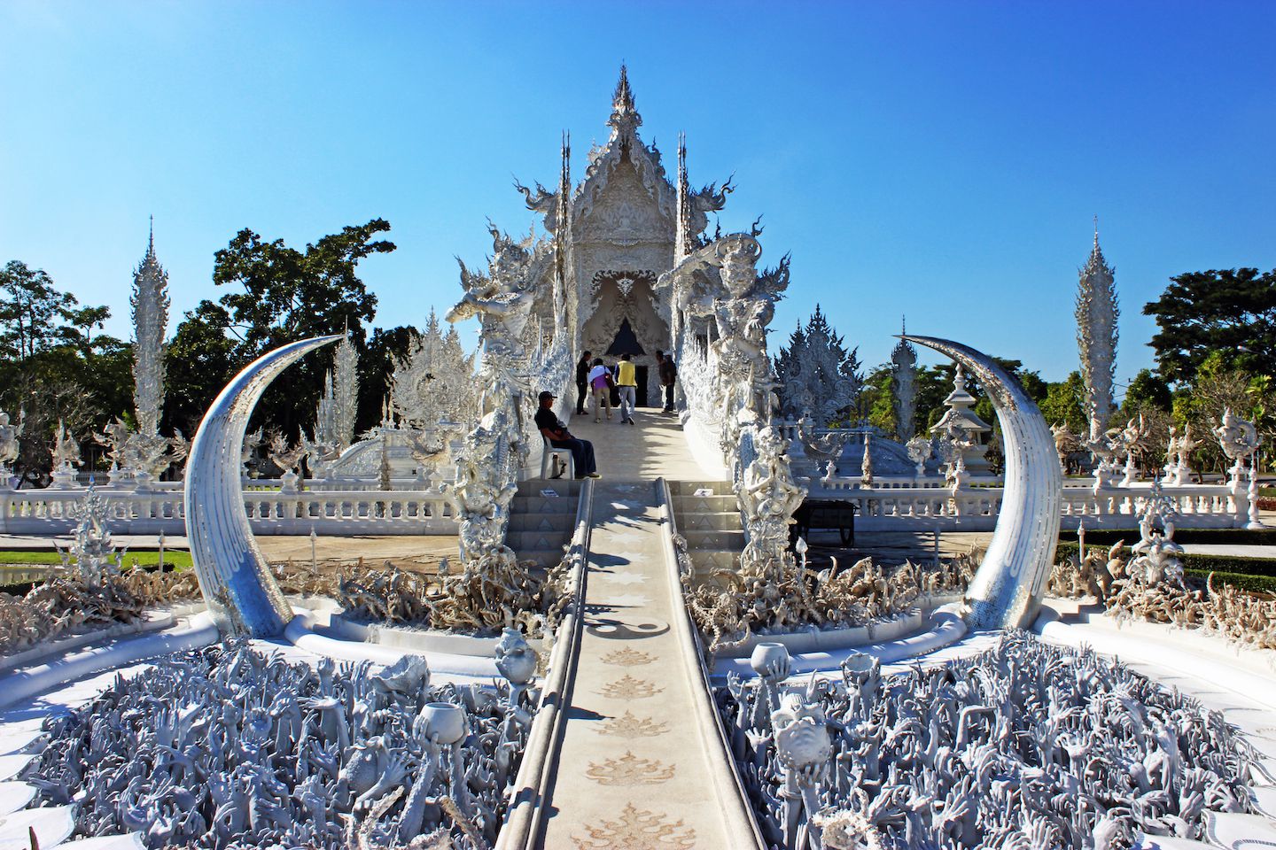 Bridge crossing the pond of the White Temple in Chiang Rai