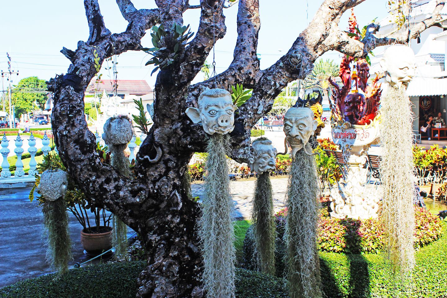 Heads hanging on the tree of the White Temple in Chiang Rai