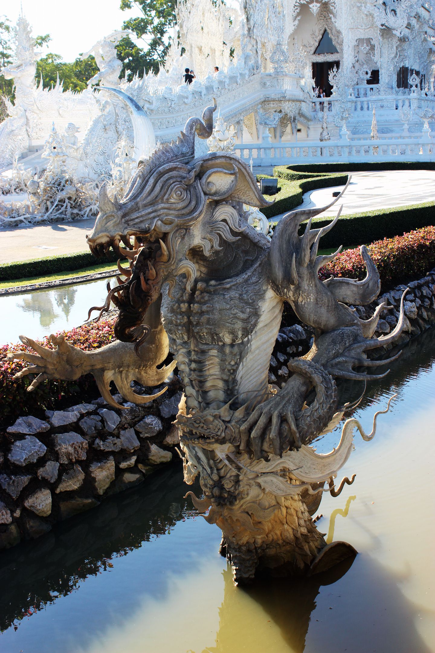Monster statue in the pond of the White Temple in Chiang Rai