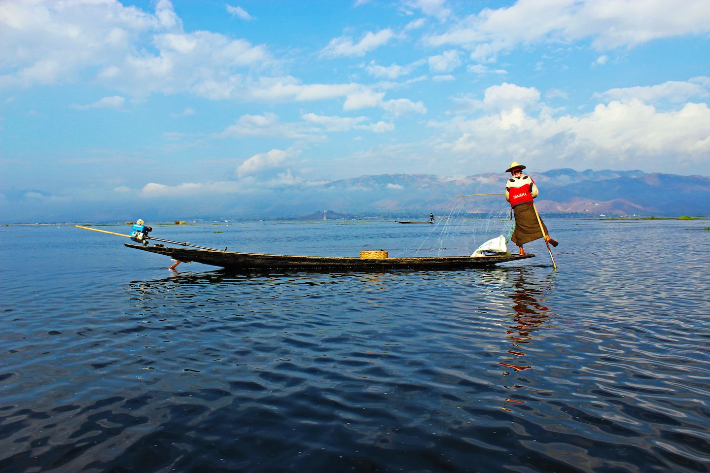 Fisherman rowing the boat with his leg, Inle Lake, Myanmar