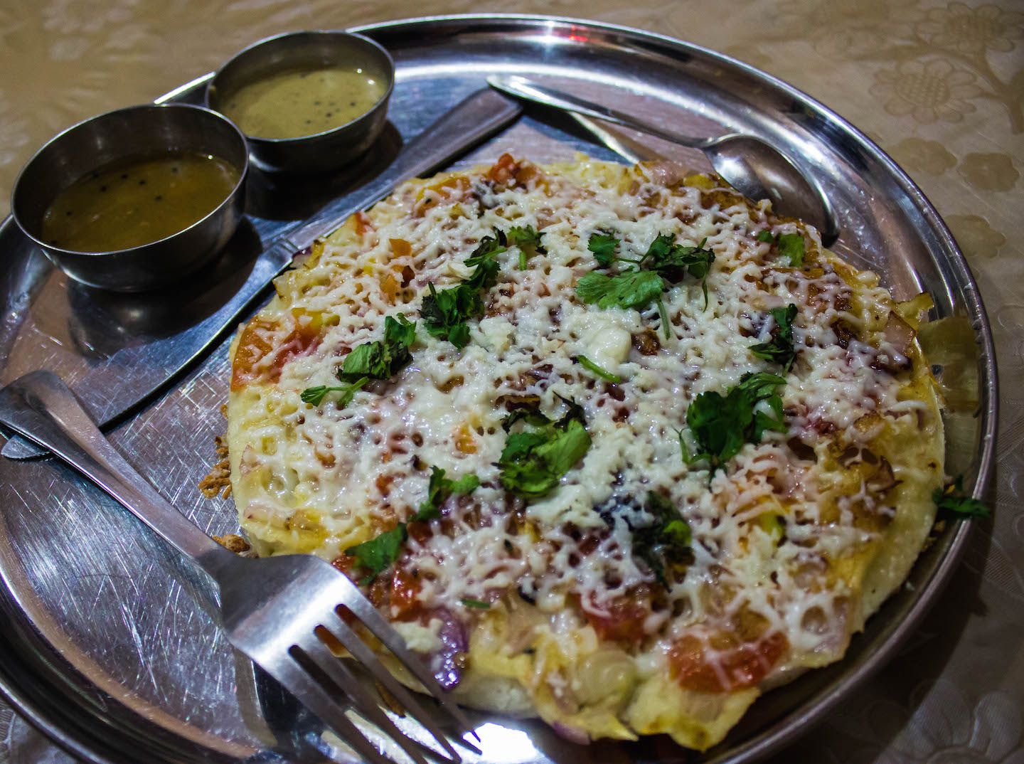 Uttapam with tomato, onion and paneer toppings, India