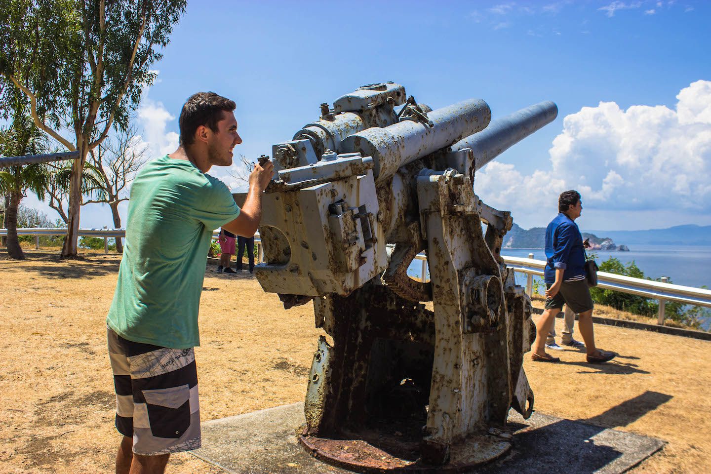 Carlos and an anti-aircraft gun, Corregidor, Philippines