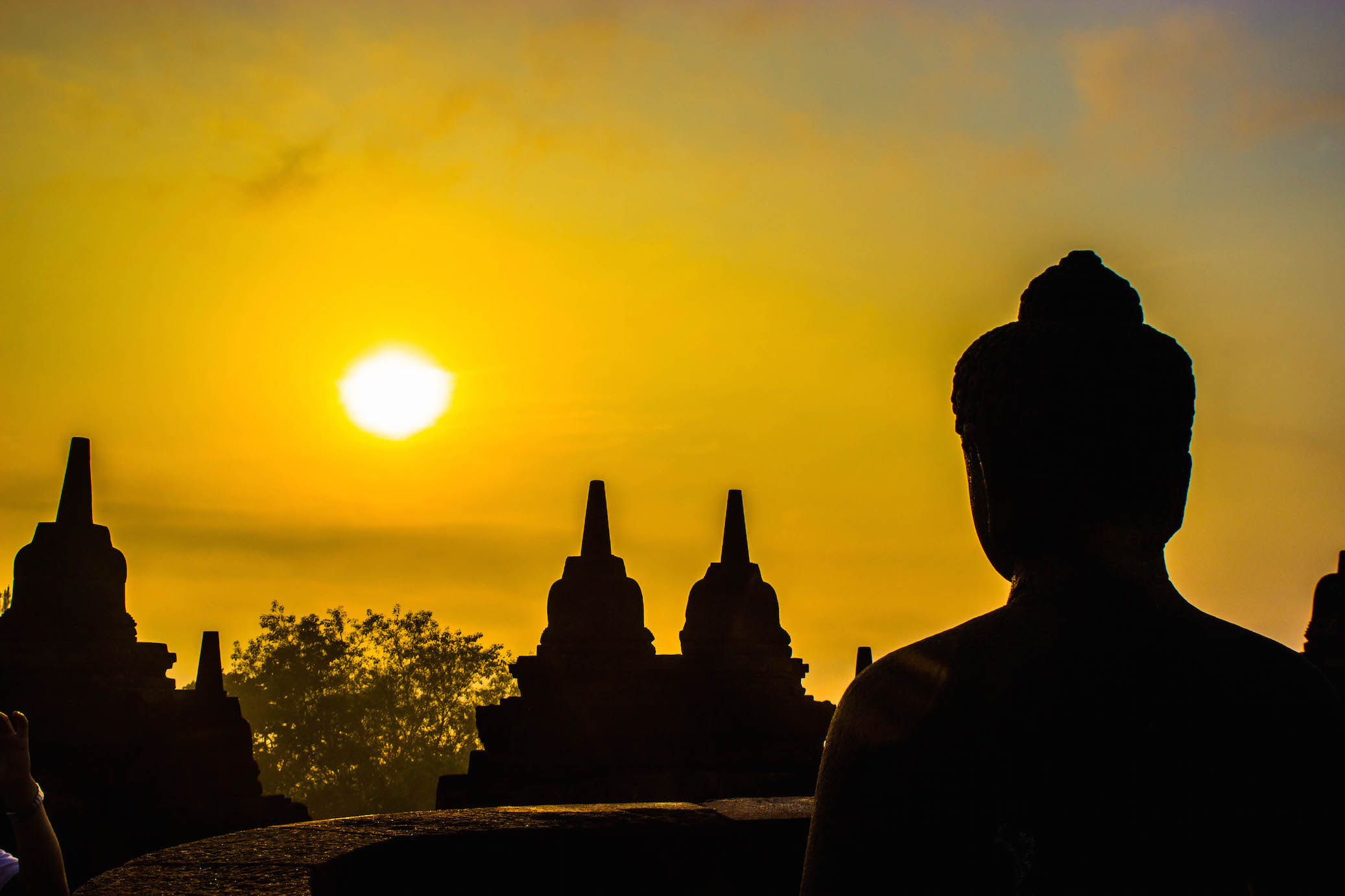 Buddha watching the sunrise, Borobudur, Indonesia