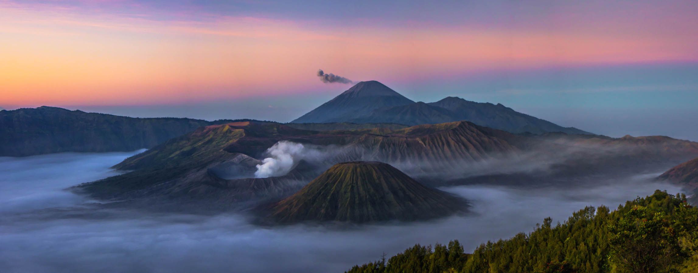 Panoramic view with Mt. Semeru spewing ash, Indonesia