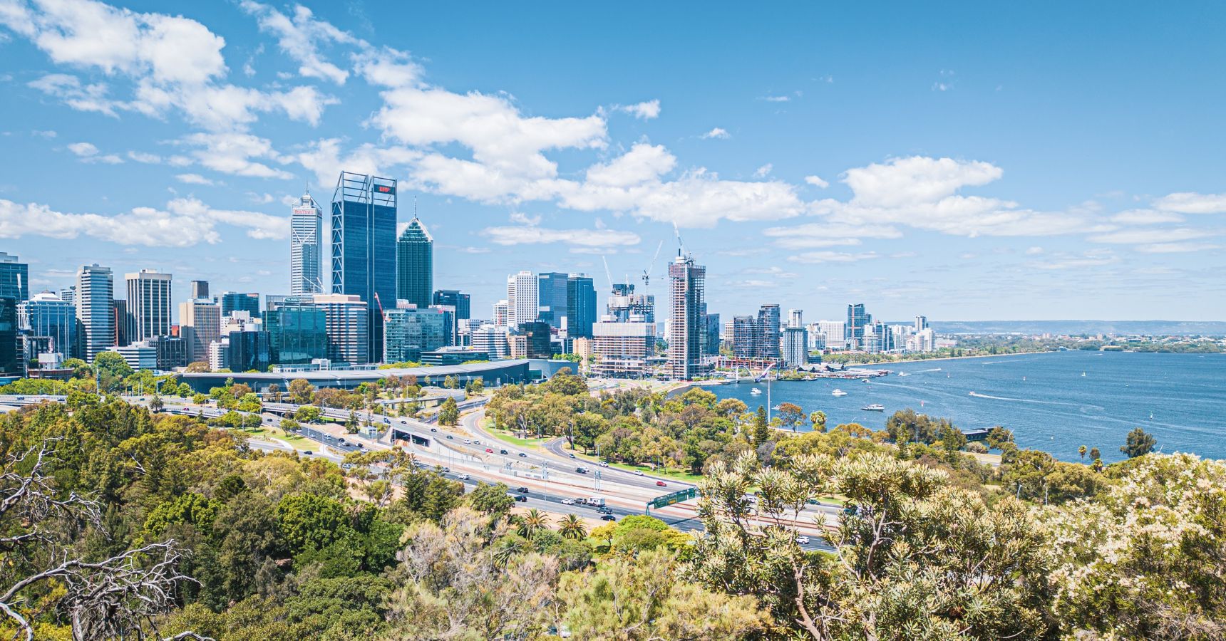 Perth city skyline with Swan River and Kings Park.