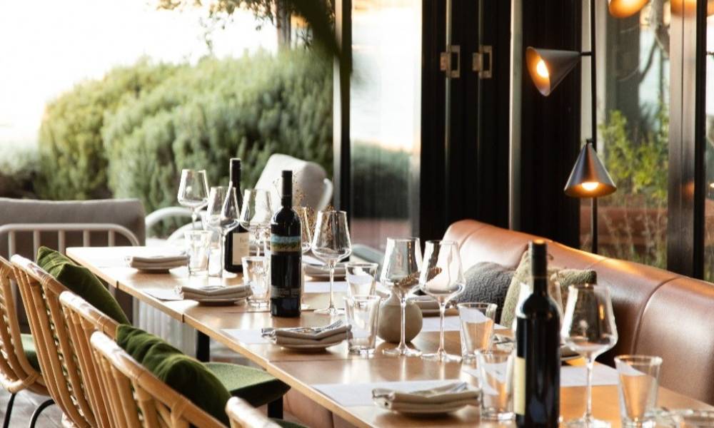 Indulge in dinner at Cooee as the sun sets over the river