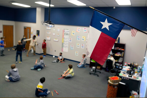 A Texas flag at an elementary school in Murphy, Texas, this month. Teachers in the state planned to participate in a sickout.
