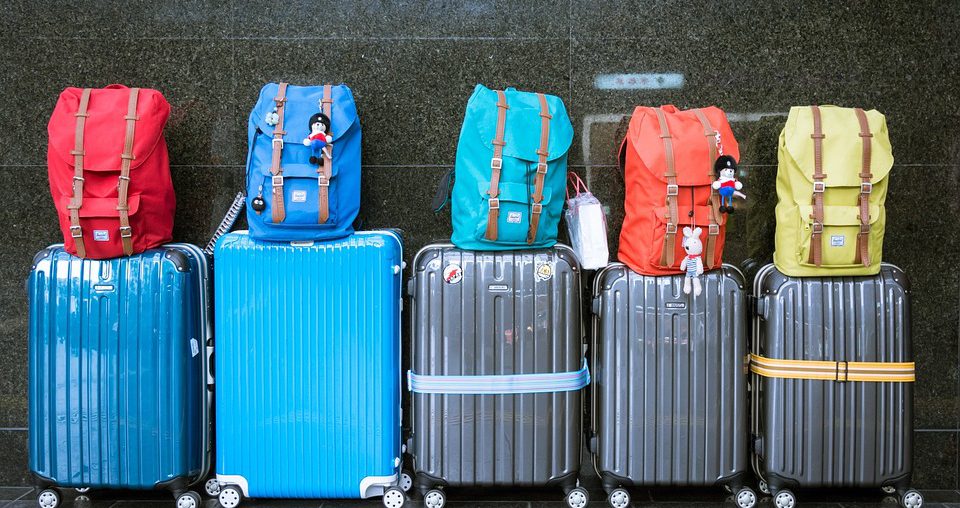 five suitcases and backpacks for family travel