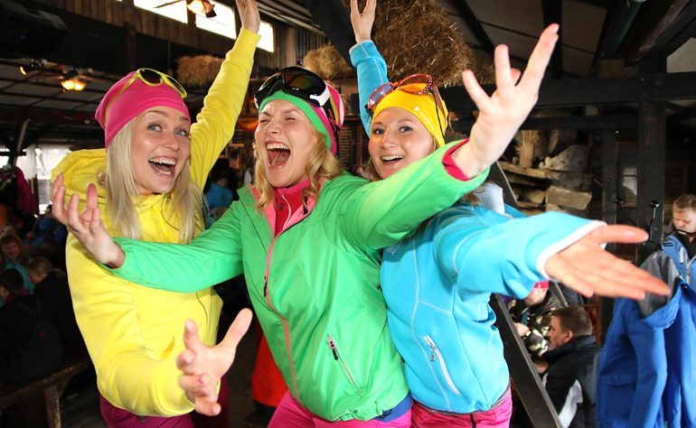 group of girls in bright clothing at apres ski