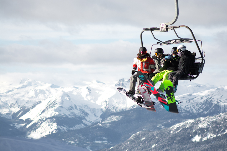 group of snowboarders on chair lift