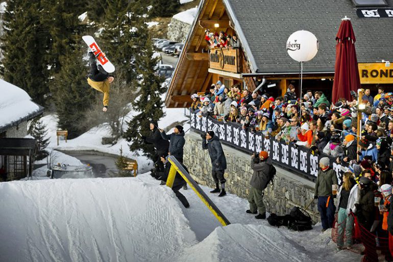 huge apres ski party at rond point meribel with snowboarder doing filp in front of crowd