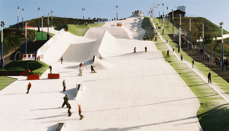 skiers and snowboarders on dry ski slope