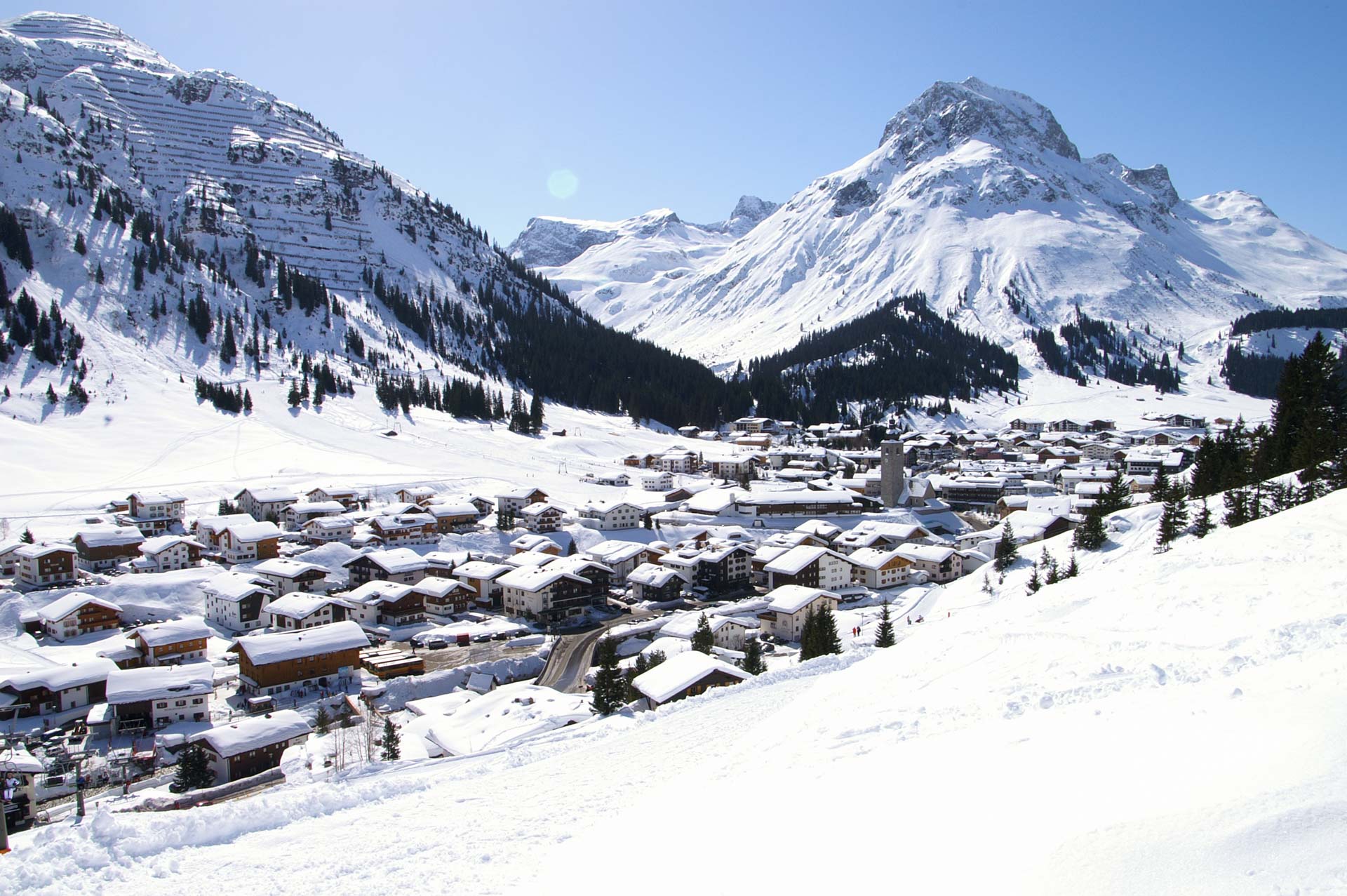 The pretty Austrian ski village of Lech am Arlberg lying between two large snow covered mountains