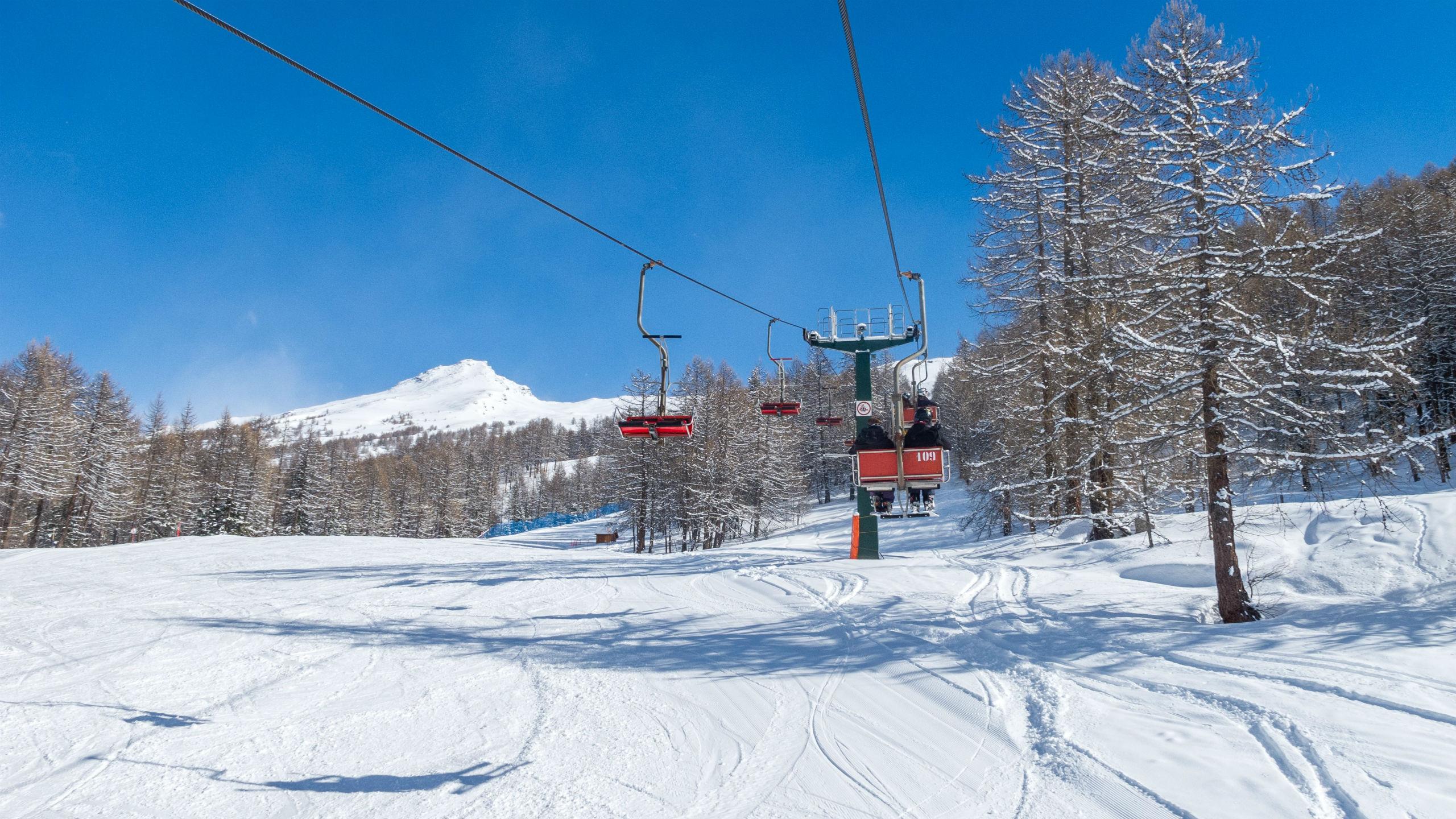 two skiers on a beginner ski lift in bardonecchia