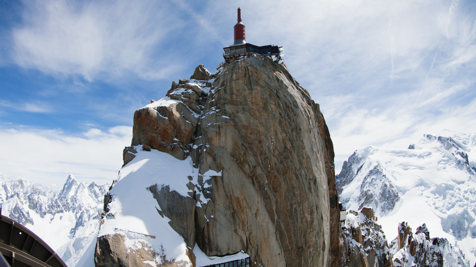 High above Chamonix, the needle of the Aiguille du Midi lift station sits in the sky at 3842m