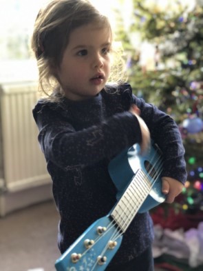 Girl Playing Toy Guitar