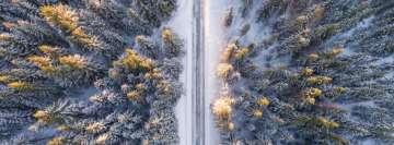 Aerial Photo of Road Crossing Snowy Forest Facebook Banner