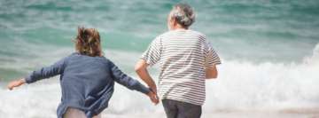 Elderly Couple Running on The Beach Facebook Wall Image