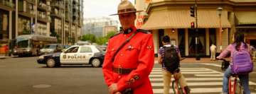 Man in Uniform Standing on Sidewalk Facebook Wall Image