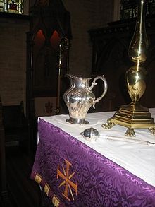An aspergillum (sprinkler) and silver ewer of holy water on the altar, prepared for asperges (Cathedral Church of Saint Matthew, Dallas, Texas).