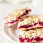 Luscious, buttery, sweet and tart glossy cranberry sauce crumble bars are made with a sweet crumble dough that doubles as a topping. A classic and super easy gorgeous and delicious holiday dessert. You won't be able to eat just one!
